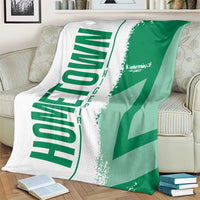 Green and white Nigeria flag and map blanket, laid across armchair