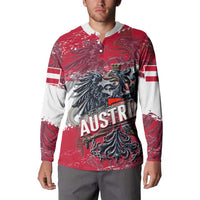 Red button sweatshirt with eagle crest front graphic and white stripe accents on sleeves