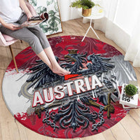 Red and gray round rug with Austria lettering and black eagle coat-of-arms graphic