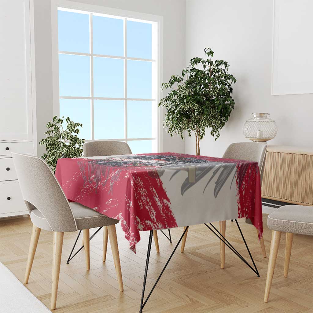 Red and gray grunge-style tablecloth with Austria crest print on dining table