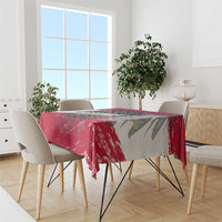 Red and gray grunge-style tablecloth with Austria crest print on dining table
