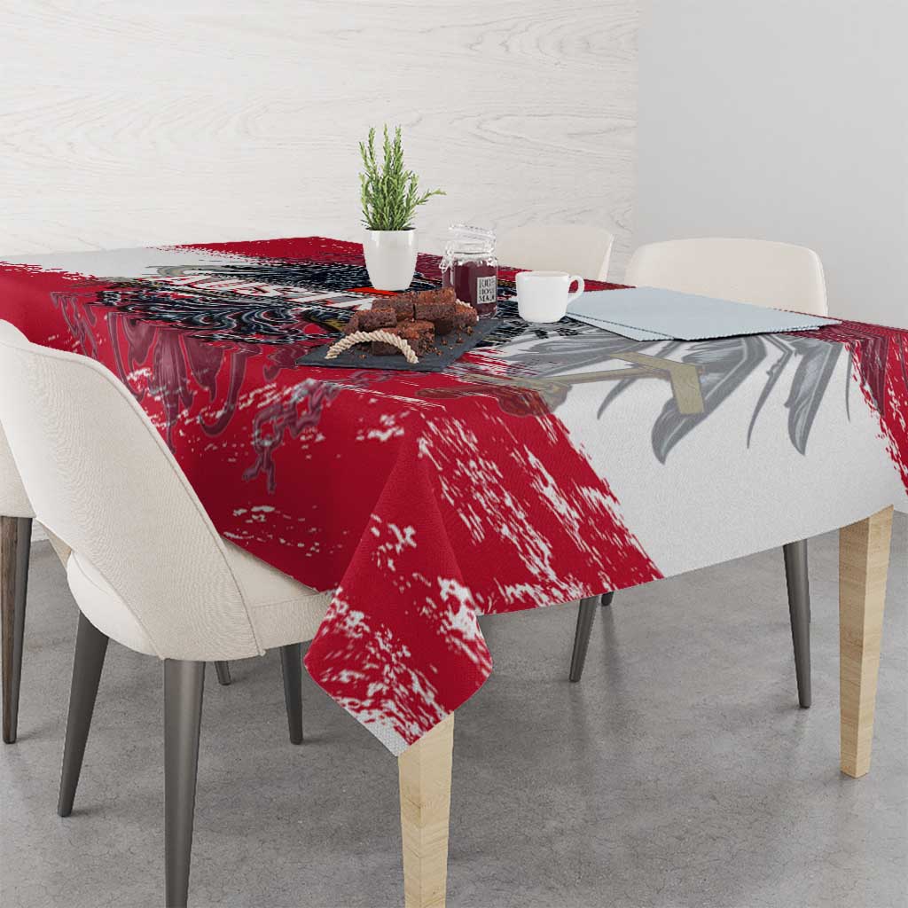 Red grunge-style tablecloth with crest graphic draped across dining table