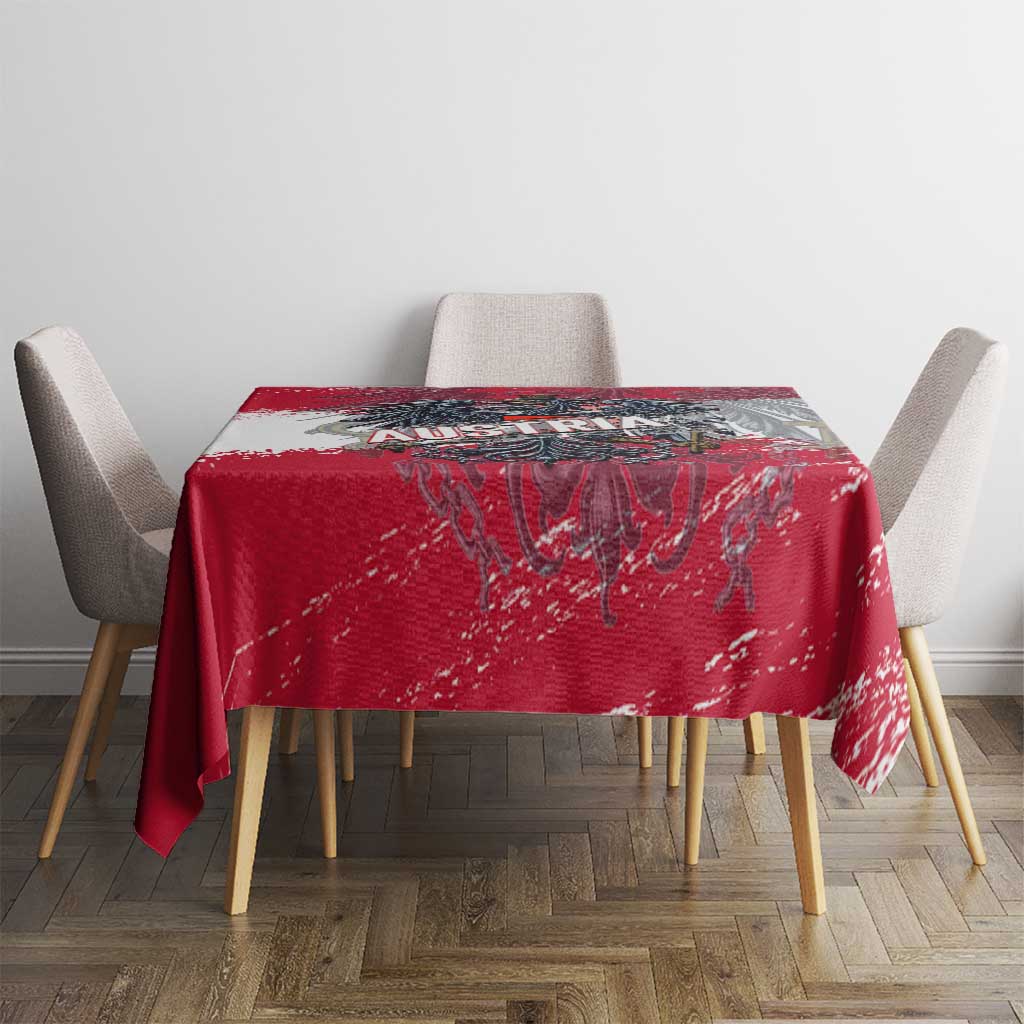 Red grunge-style tablecloth with crest print on table, chairs on both sides