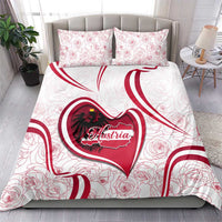 White bedding set with two red rose-pattern pillowcases; Austria heart emblem centered