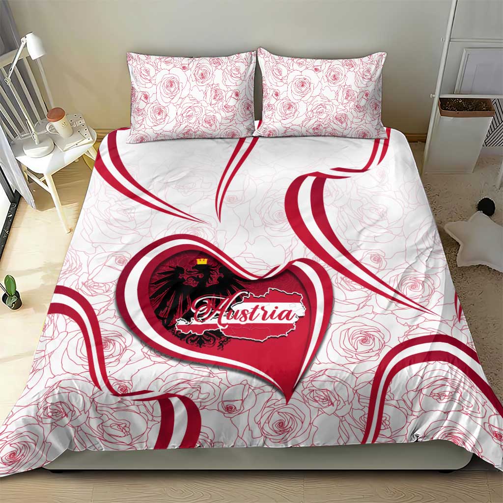 White bedding set with Austria heart emblem and rose pattern; two matching red-trim pillowcases