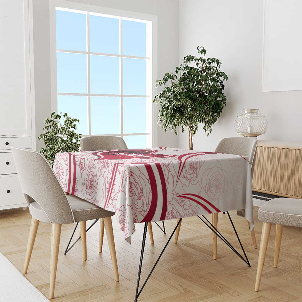 Red and white Austria-themed tablecloth draped over dining table with chair set