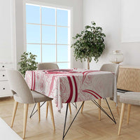 Red and white Austria-themed tablecloth draped over dining table with chair set