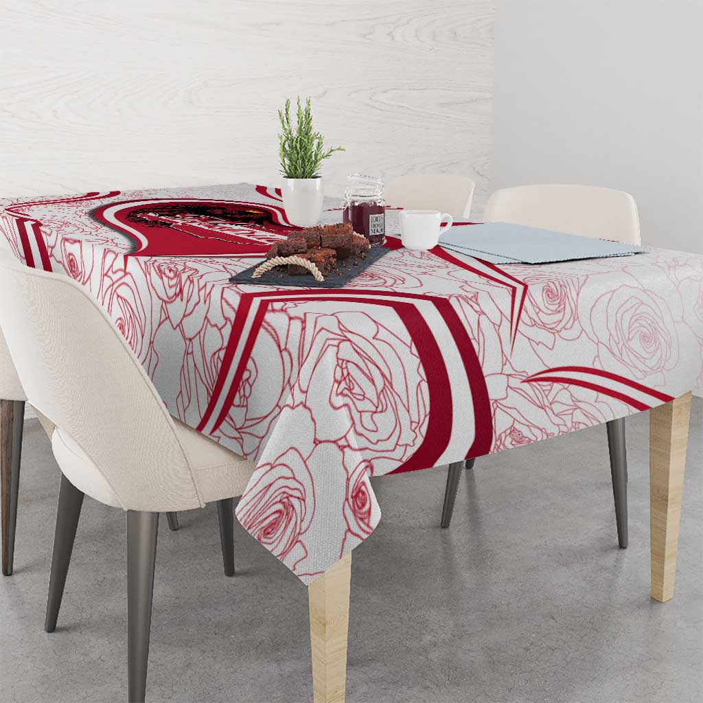 Red and white tablecloth with bold Austria crest and rose-line motif on dining table