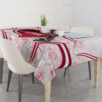 Red and white tablecloth with bold Austria crest and rose-line motif on dining table