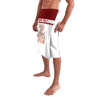 White wrap skirt with red check waistband and colorful crest print, side view