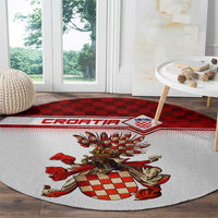 Round rug with coat of arms crest centered on white field and red checker strip