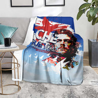 Cuba Che Guevara blanket on floor, light blue with Che face print, red splashes, doves