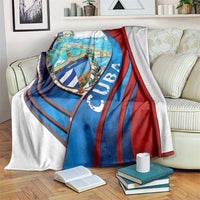 Cuba map blanket with coat of arms shield, blue and red striped design, folded over bed