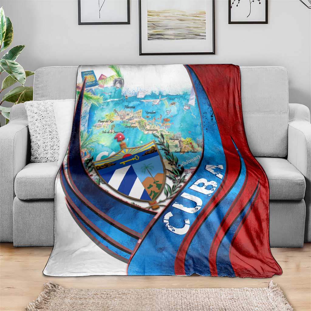 Caribbean map blanket with coat of arms shield, blue and red striped pattern, on gray sofa