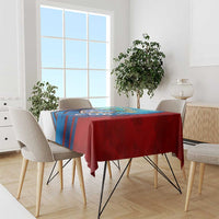 Red and blue Cuban map tablecloth draped over a dining table with chairs.