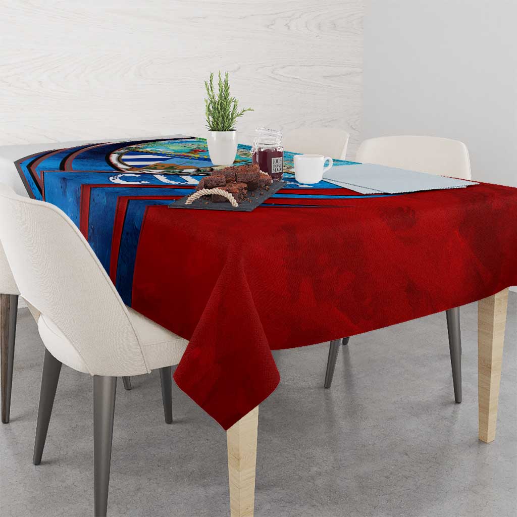 Red and blue Cuban map tablecloth with bold graphic border on dining table.