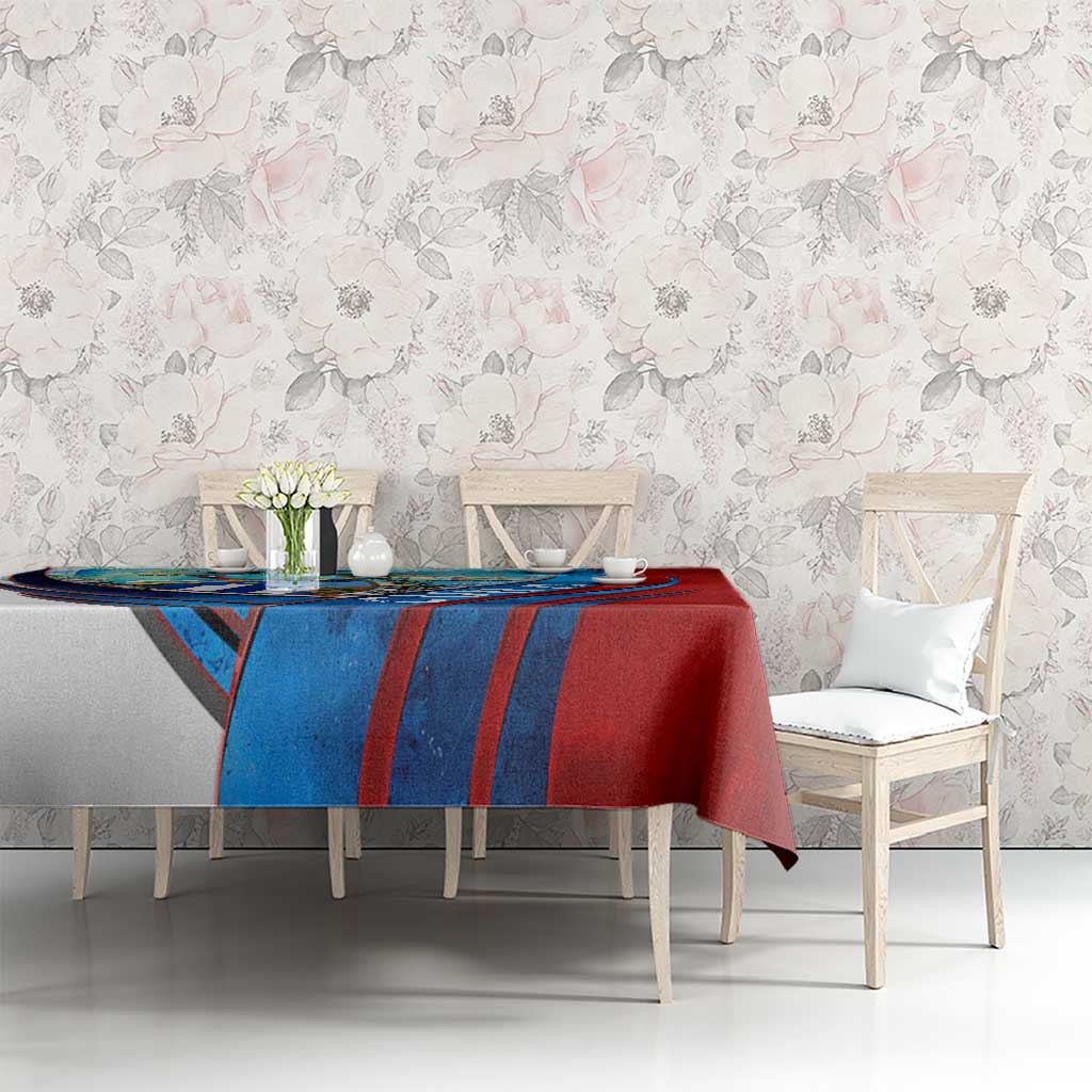 Red and blue Cuban map tablecloth on dining table with chairs in the room.