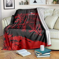 Black and red lion print blanket with 'CZECH REPUBLIC' logo, draped on sofa