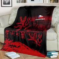 Black and red lion print blanket with 'CZECH REPUBLIC' logo, draped on couch