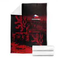 Black and red lion print blanket with 'CZECH REPUBLIC' logo, with stacked white towels