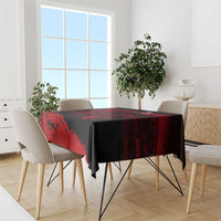 Square tablecloth on dining table, black base with red lion-themed stripe motif