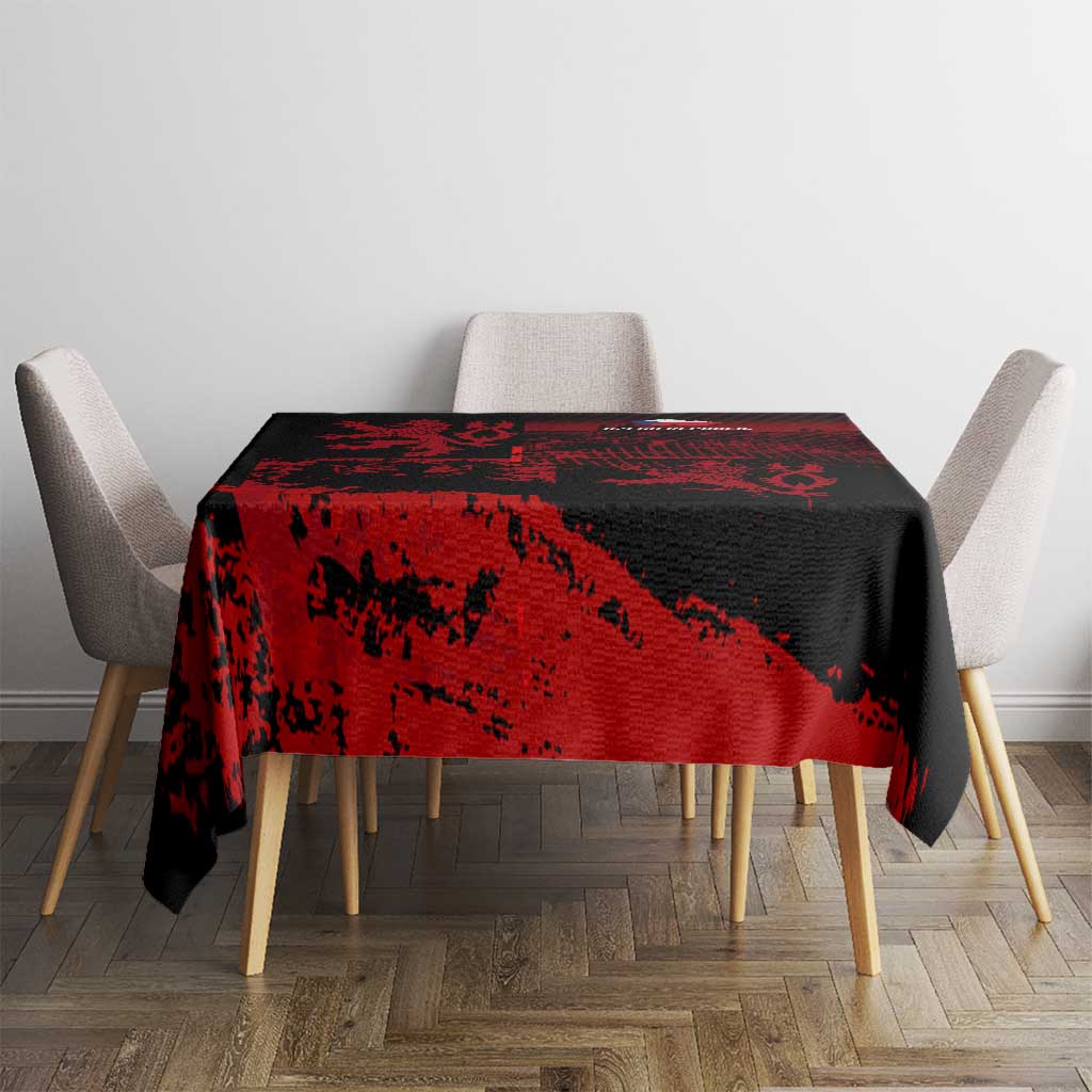 Black and red lion crest tablecloth on dining table with four chairs