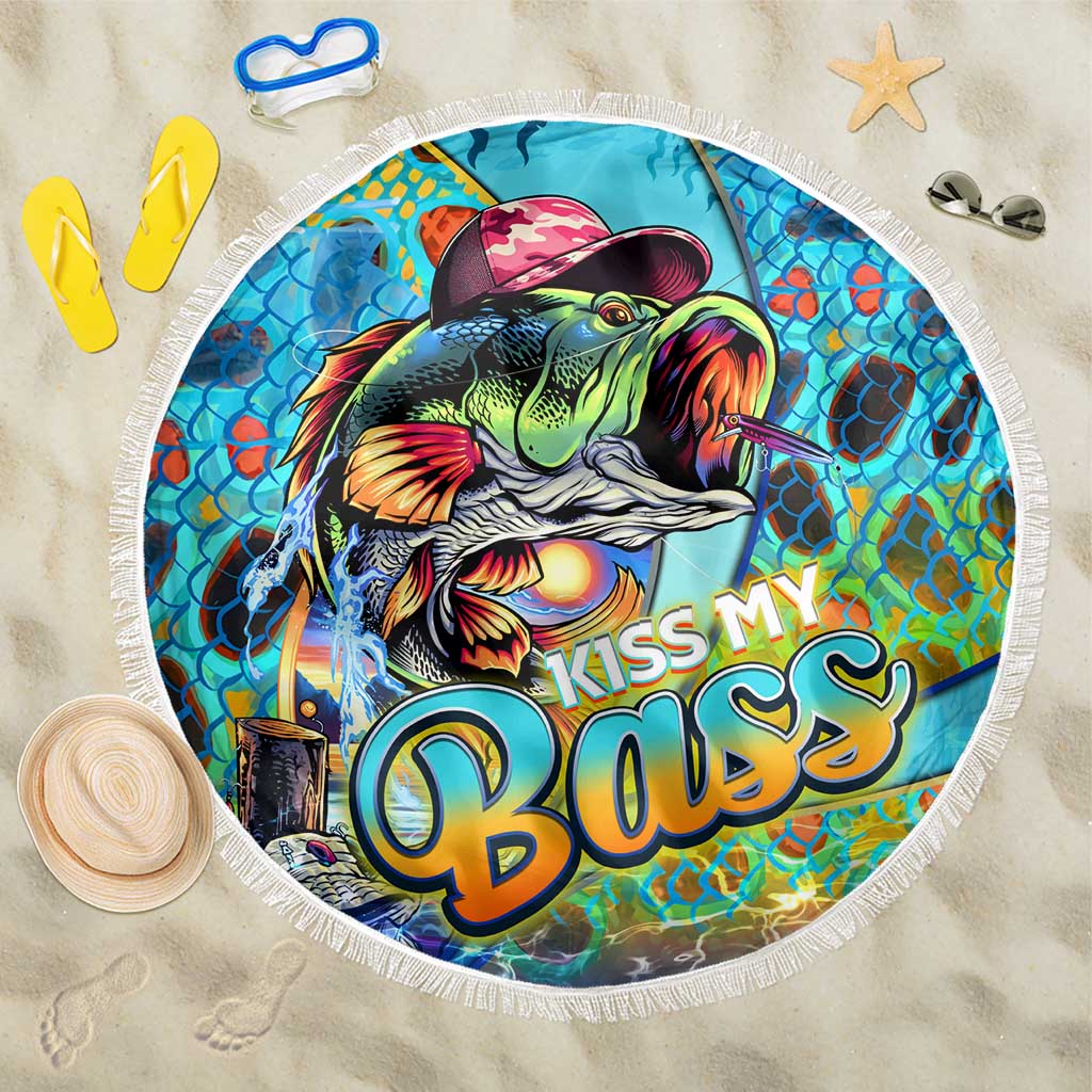 Round beach blanket with colorful fish art and fringe edge, reads 'Kiss My Bass'.