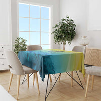 Fish tablecloth in blue-teal with yellow border stripe, draped over dining table