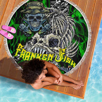 Round green skull fishing beach blanket with white fringed edge, used by a person