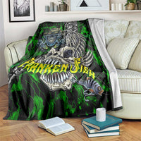 Green skull fishing blanket with skeleton fish and claw art, draped on couch