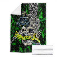 Green skull fishing blanket with skeleton fish skull graphic, stacked with white towels