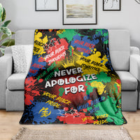Multicolor graphic throw blanket with large white lettering, draped on sofa