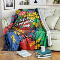 Multicolor graphic blanket with white headline text, draped across couch with books