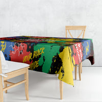 Multicolor printed tablecloth draped over dining table with chairs