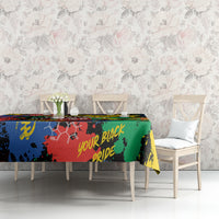 Multicolor printed tablecloth on dining table against a floral wall