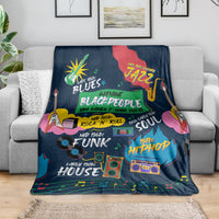 African blanket in dark blue with vibrant music-themed print, folded over sofa arm