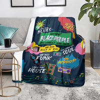 African blanket in dark blue with colorful music-themed graphic, draped on seat