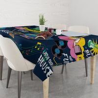 Dark blue music tablecloth draped on dining table with colorful notes and instruments