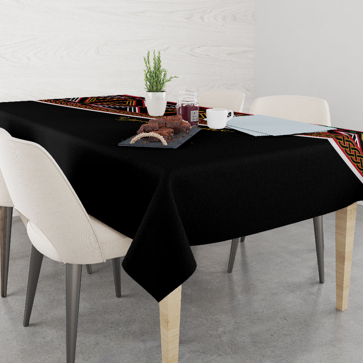 Black tablecloth with colorful trim and geometric print along the side edge