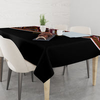 Black tablecloth with colorful trim and geometric print along the side edge