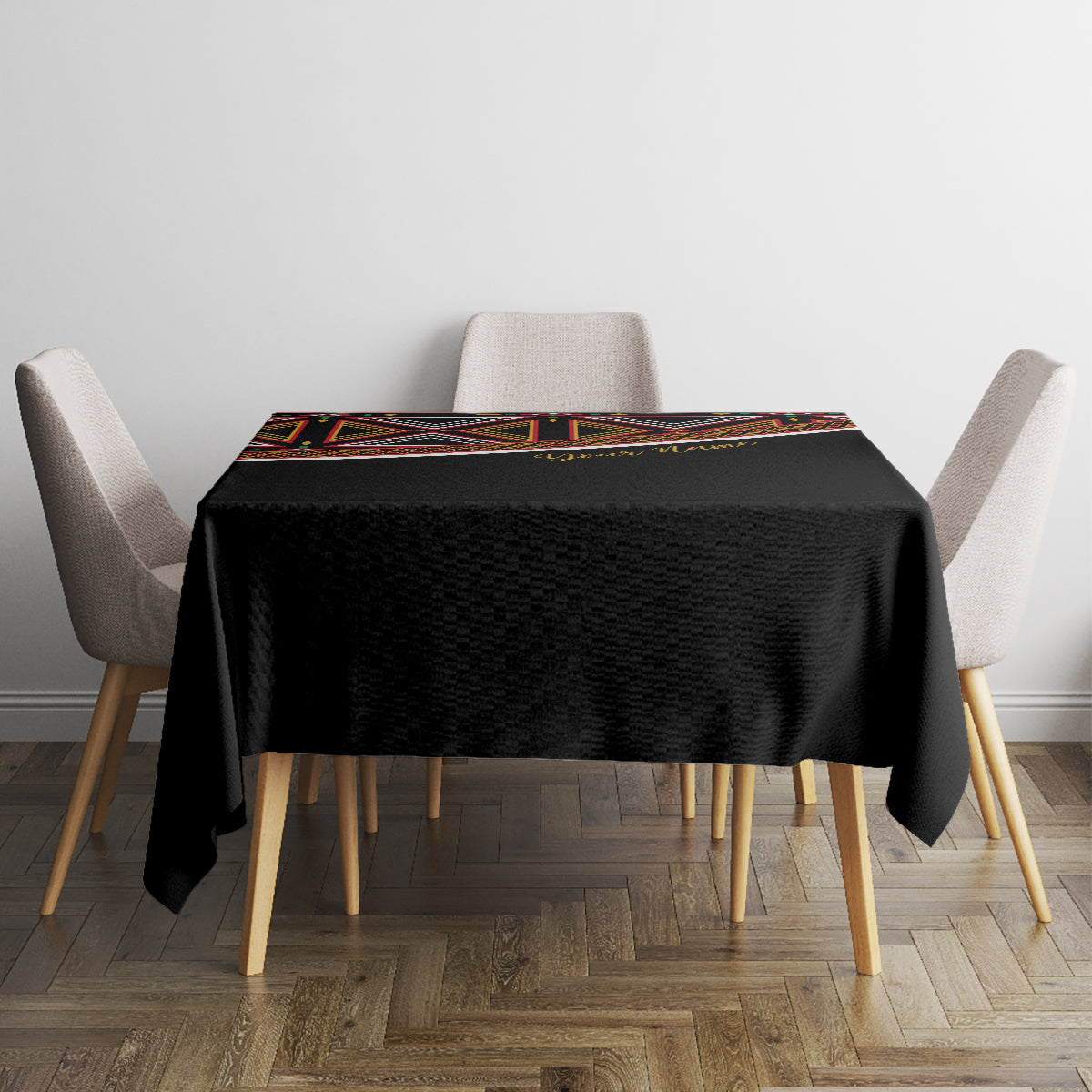 Black square tablecloth with colorful patterned border on top surface