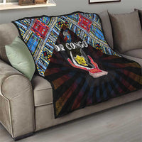 Black throw quilt on sofa with blue red geometric border and central peace emblem