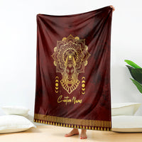 Red personalized Anubis-themed blanket with gold face design and striped hem, draped