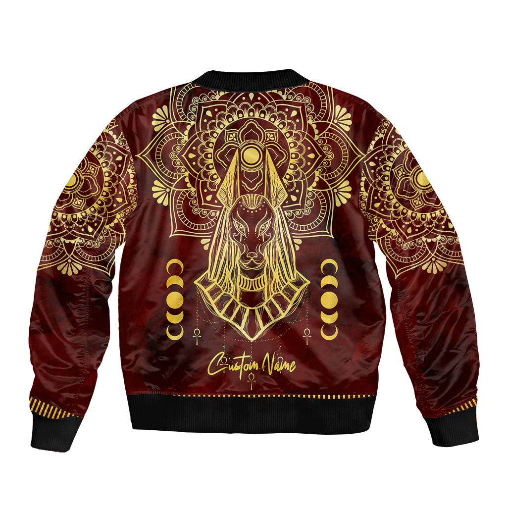 Red bomber jacket with gold Anubis graphic on back, 'Christian Vane' text, black trim