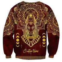Red unisex sweatshirt with gold Anubis portrait, mandala pattern, and cursive text