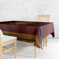 Red tablecloth with gold Anubis design and yellow geometric border