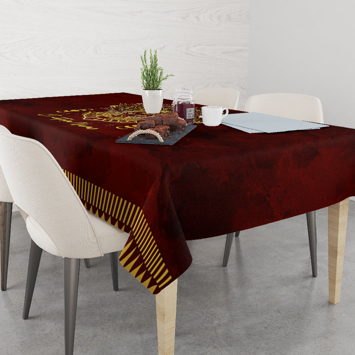 Red tablecloth with gold Anubis print and yellow striped border