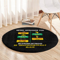 Black round carpet with pride typography and colorful label graphics across the center