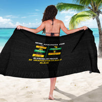 Black sarong worn as a wrap skirt with slogan text and colorful blocks
