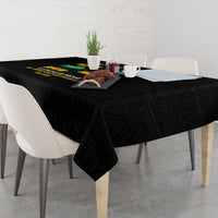 Black tablecloth with decorative print over dining table and chairs